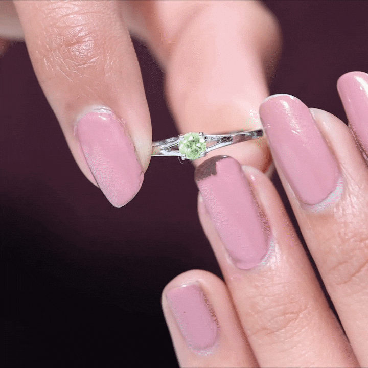 Natural half-carat peridot promise ring with diamond accents by Rosec Jewels, showcasing a vibrant green peridot gemstone and sparkling diamonds.