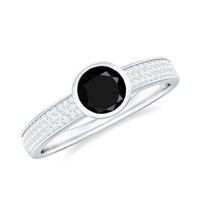 Natural black spinel bezel set engagement ring with diamond side stones, featuring a sleek design and sparkling accents.