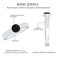 Natural black spinel bezel set engagement ring with diamond side stones, featuring a sleek rose gold band and intricate detailing.
