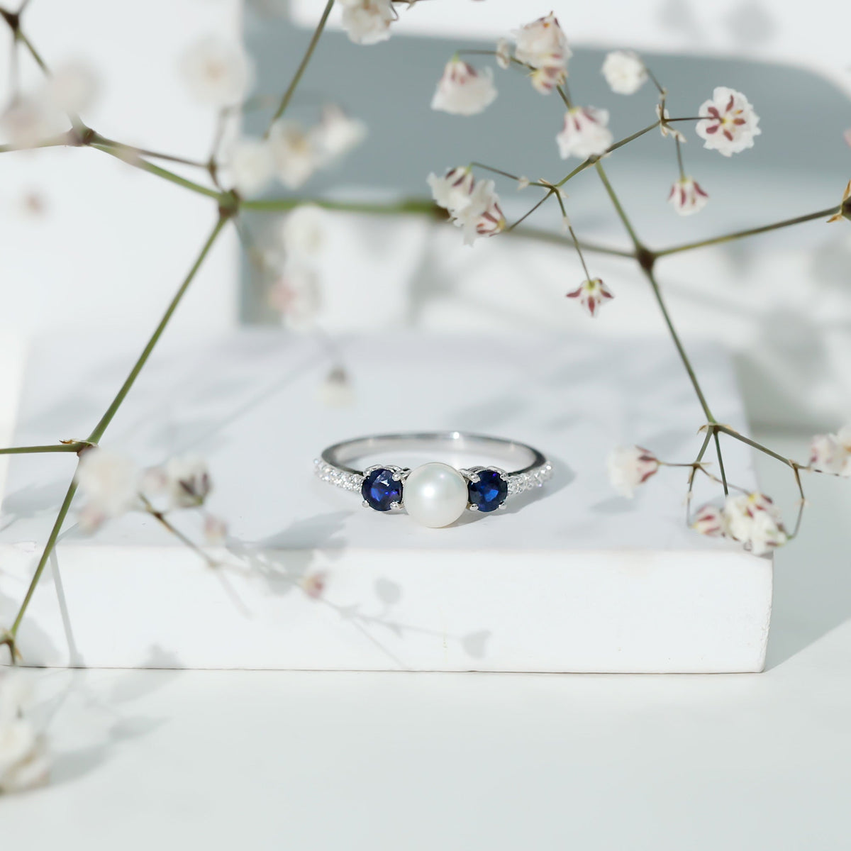Natural freshwater pearl and blue sapphire 3-stone engagement ring by Rosec Jewels featuring diamonds and elegant design.