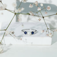 Natural freshwater pearl and blue sapphire 3-stone engagement ring by Rosec Jewels featuring diamonds and elegant design.