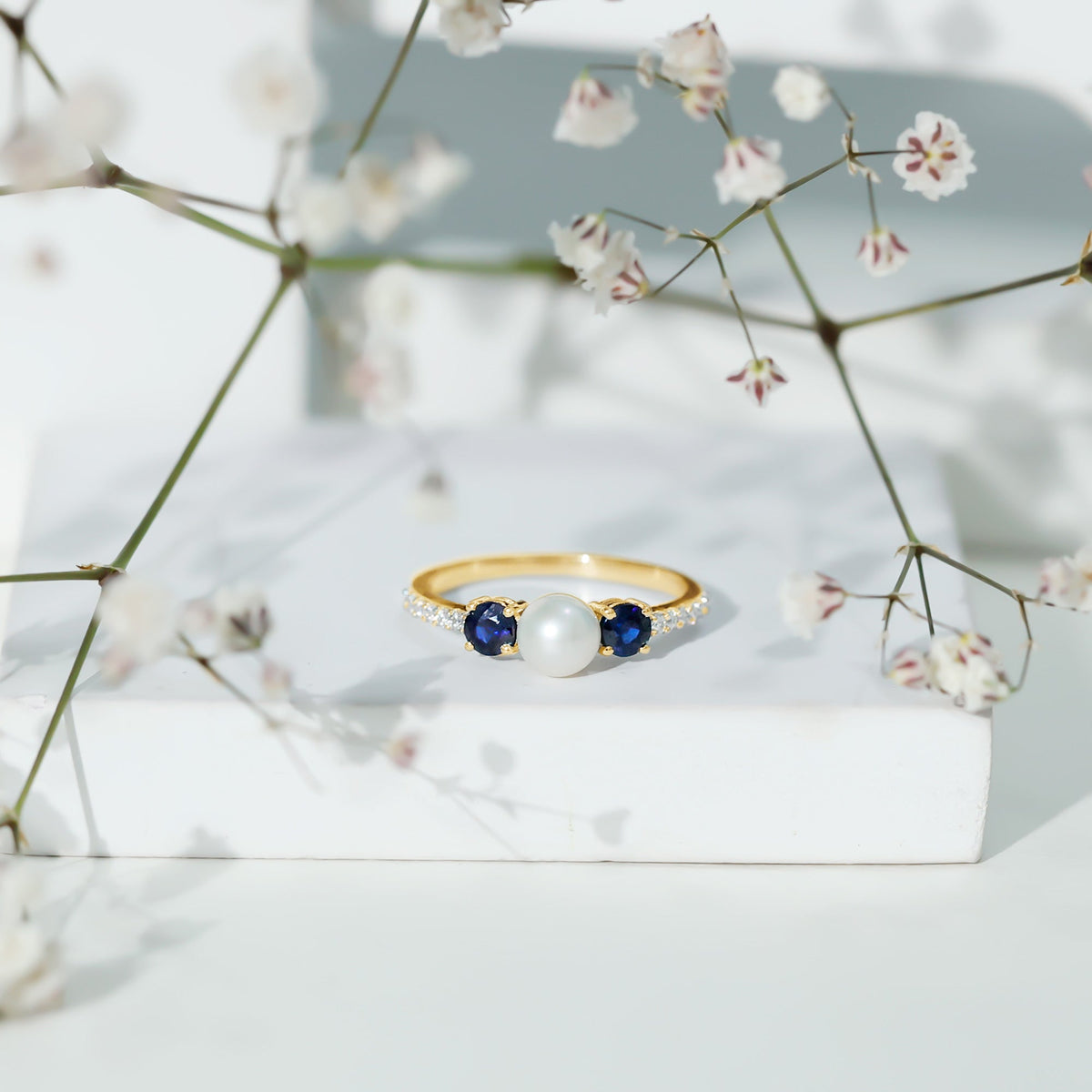 Natural freshwater pearl, blue sapphire, and diamond 3-stone engagement ring by Rosec Jewels featuring elegant design and fine craftsmanship.
