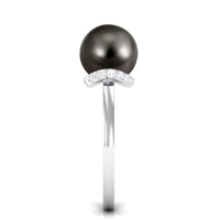 Tahitian pearl solitaire engagement ring with diamond halo from Rosec Jewels, featuring a lustrous black pearl and sparkling diamond accents.