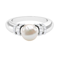 Freshwater pearl solitaire engagement ring with diamond accent by Rosec Jewels, featuring a 7.48-carat pearl and elegant design.