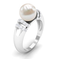 Freshwater pearl solitaire engagement ring with diamond, set in a Rosec Jewels ring, showcasing a 7.48-carat pearl and sparkling diamond.