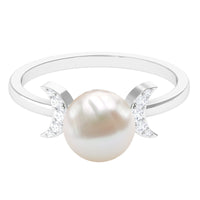 Natural 7.4 carat freshwater pearl solitaire engagement ring with diamond accents, featuring a rose gold band from Rosec Jewels.