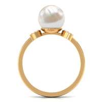 Natural 7.4 carat freshwater pearl solitaire engagement ring with diamond accents, featuring a sleek band and elegant design.