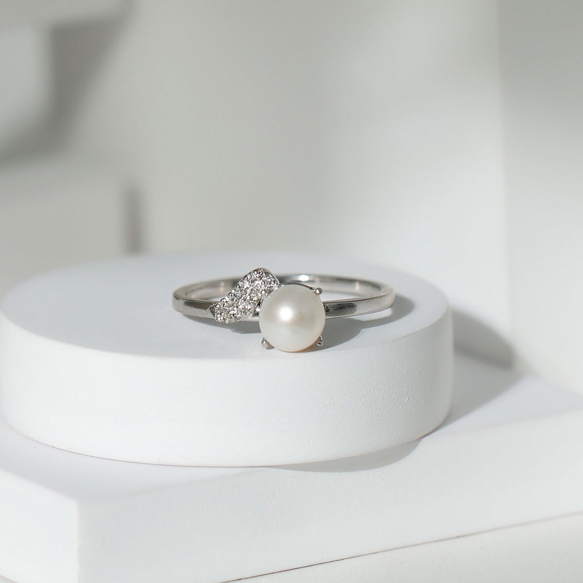 Cultured 3-carat freshwater pearl solitaire engagement ring with diamond accents from Rosec Jewels, featuring a sleek gold band.