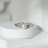 Cultured 3-carat freshwater pearl solitaire engagement ring with diamond accents from Rosec Jewels, featuring a sleek gold band.