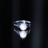 Cultured freshwater pearl and blue sapphire engagement ring from Rosec Jewels, featuring a delicate band with elegant gemstones.