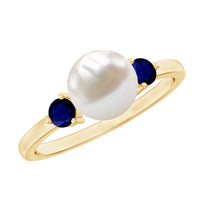 Cultured freshwater pearl engagement ring with blue sapphire and silver band from Rosec Jewels, showcasing a sparkling central gemstone.