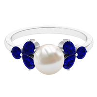 Natural 7.4 carat freshwater pearl engagement ring with blue sapphire trio, featuring elegant rose gold band by Rosec Jewels