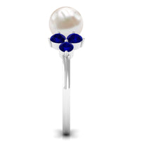 Natural 7.4 carat freshwater pearl engagement ring with blue sapphire trio from Rosec Jewels, showcasing elegant design and sparkling gemstones.