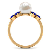 Natural 7.4 carat freshwater pearl engagement ring with blue sapphire trio by Rosec Jewels, featuring elegant ring design.