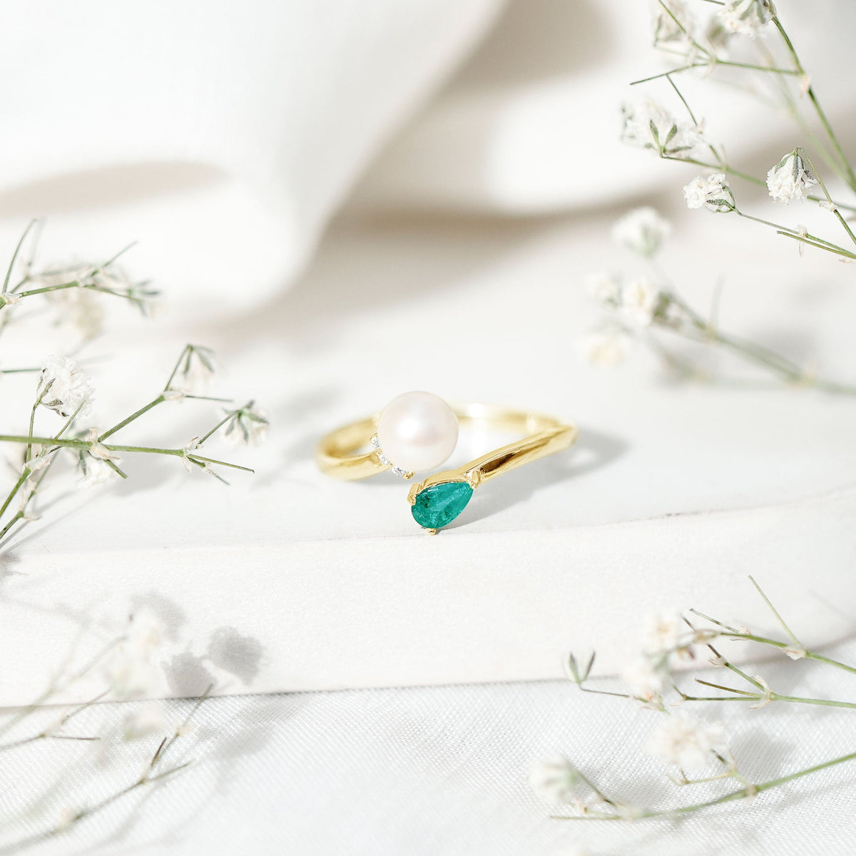 Cultured freshwater pearl and emerald toi et moi promise ring by Rosec Jewels, featuring elegant pearl and green gemstone design.