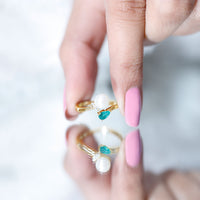 Cultured freshwater pearl and emerald Toi Et Moi promise ring from Rosec Jewels, featuring a delicate pearl and emerald setting.