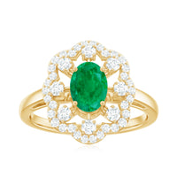 Rosec Jewels 0.7 Carat oval emerald engagement ring with diamond accent, featuring a sleek gold band and intricate design details.