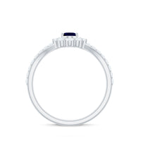 Oval cut blue sapphire and diamond chevron ring by Rosec Jewels, showcasing a sparkling gemstone design and intricate metalwork.