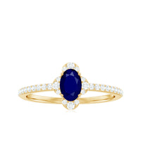 Oval blue sapphire engagement ring with diamond accents by Rosec Jewels, showcasing a natural 0.6 carat sapphire and sparkling diamonds.