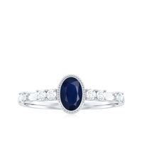 Vintage-style blue sapphire oval engagement ring with diamond accents from Rosec Jewels, showcasing intricate detailing and sparkling stones.