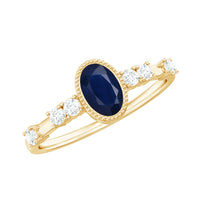 Vintage blue sapphire oval engagement ring with diamond accents from Rosec Jewels, showcasing intricate design and elegant craftsmanship.