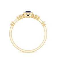 Vintage blue sapphire oval engagement ring with diamond accents from Rosec Jewels, featuring intricate metalwork and a classic design.