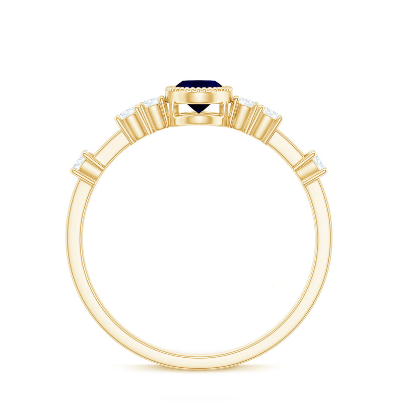 Vintage blue sapphire oval engagement ring with diamond accents from Rosec Jewels, featuring intricate metalwork and a classic design.