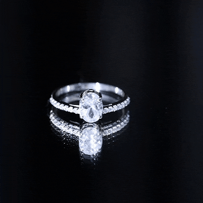 Oval cut 1.2 carat solitaire zircon engagement ring with side stones from Rosec Jewels, showcasing a shiny white band and sparkling details.