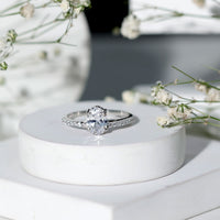 Oval cut zircon solitaire engagement ring with side stones from Rosec Jewels, showcasing the elegant jewelry design.