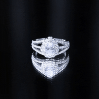Pear-shaped cubic zirconia engagement ring with split shank design by Rosec Jewels, featuring a sparkling central stone.