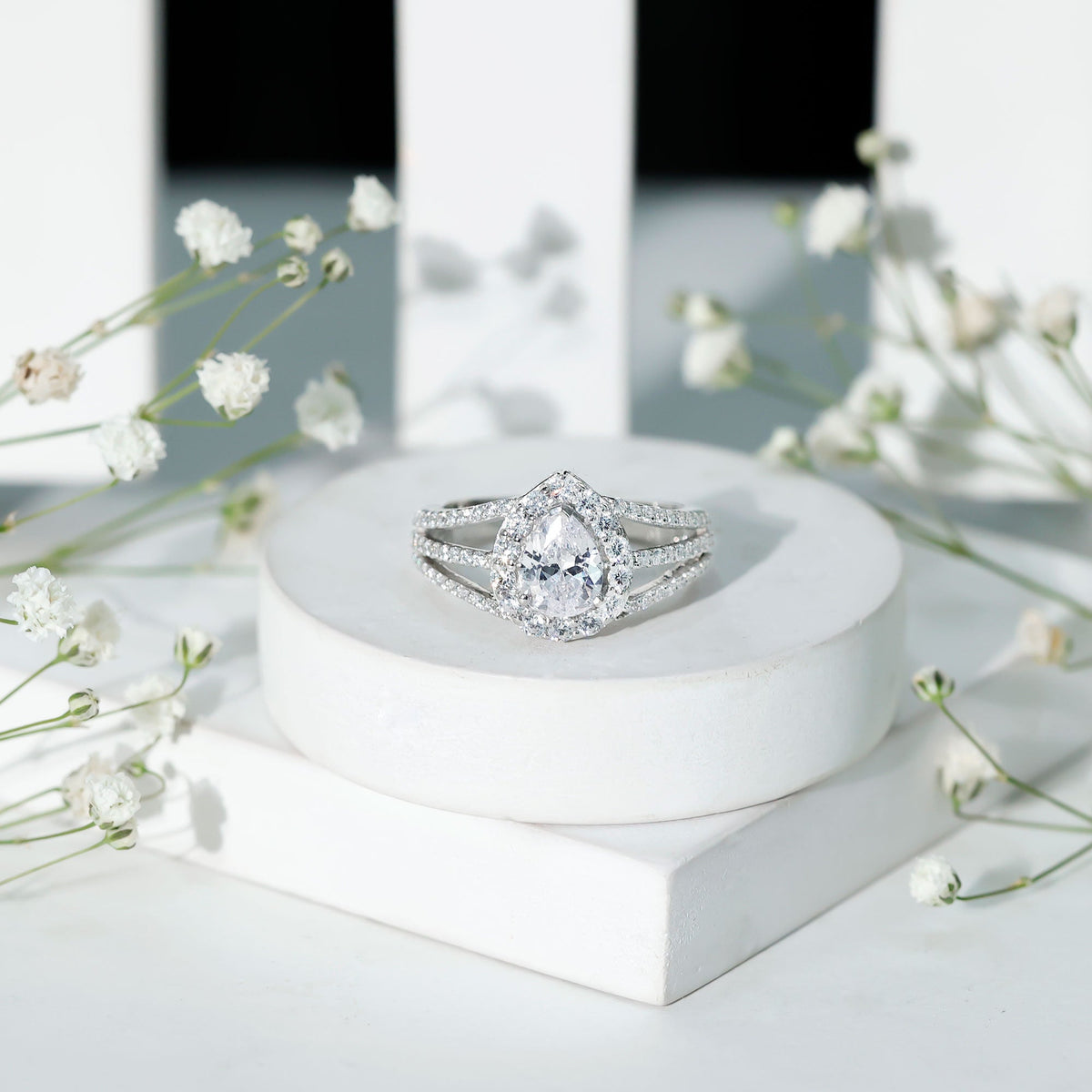 Pear-shaped cubic zirconia split shank engagement ring for women with sparkling stones, designed by Rosec Jewels.