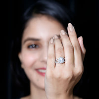 Pear-shaped cubic zirconia engagement ring with split shank design by Rosec Jewels, featuring a sparkling central stone and elegant band.
