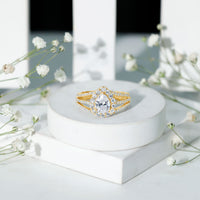 Pear-shaped cubic zirconia engagement ring with split shank design by Rosec Jewels, featuring sparkling stone settings.
