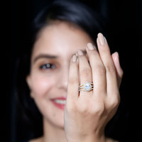 Pear-shaped cubic zirconia engagement ring with split shank design from Rosec Jewels, featuring sparkling stones on a silver band.