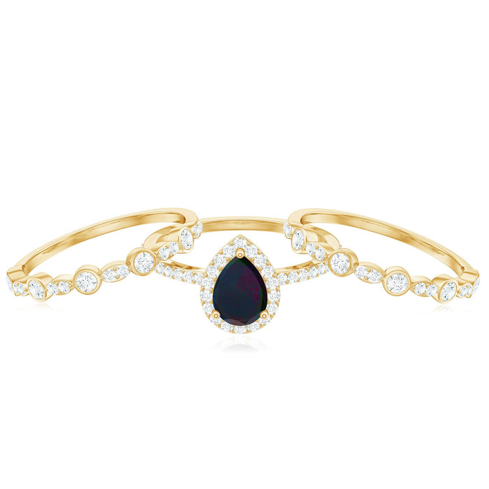 Pear cut black opal trio wedding ring set with moissanite accents, showcasing elegant rose gold bands from Rosec Jewels.