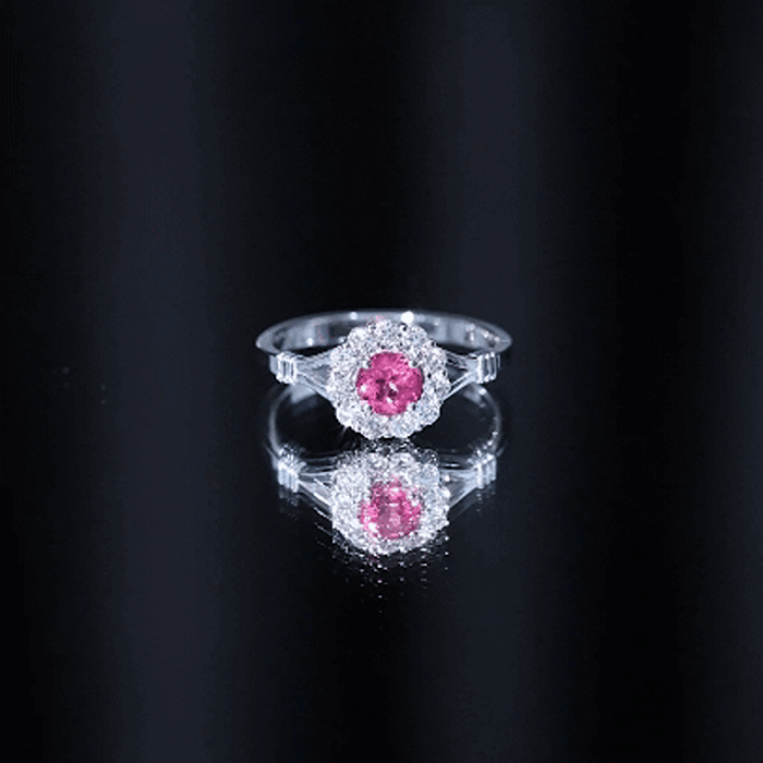 Pink tourmaline and diamond engagement ring in split shank design with Rosec Jewels branding, featuring sparkling gemstones.