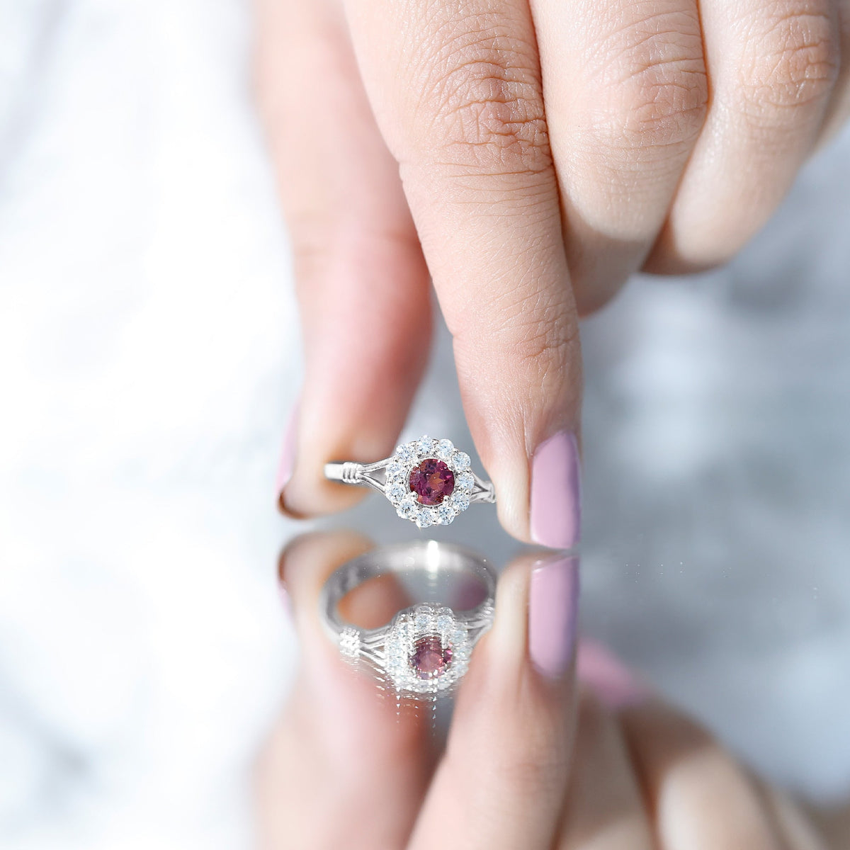 Pink tourmaline and diamond engagement ring with a split shank design by Rosec Jewels, showcasing the colorful gemstones and intricate band.