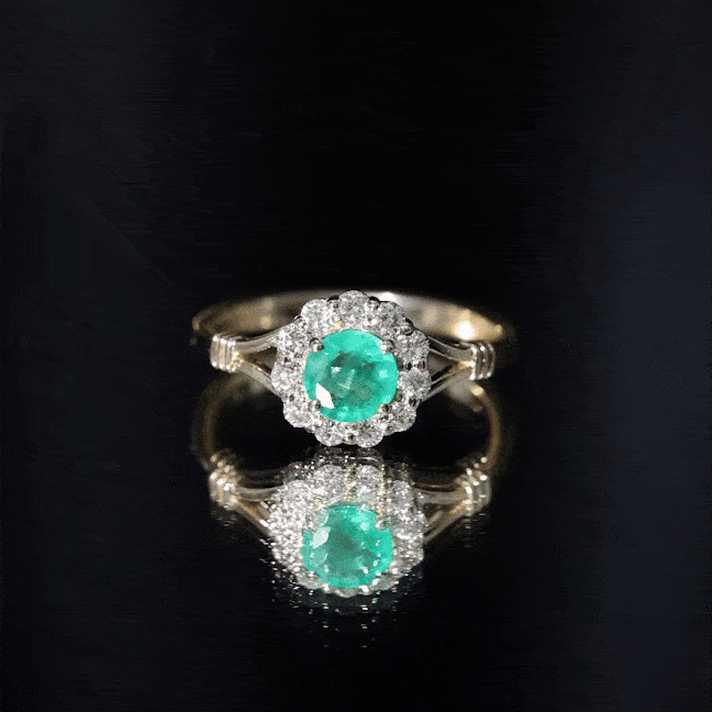 Emerald nature-inspired engagement ring with diamond halo, featuring yellow gold band and intricate floral design from Rosec Jewels.
