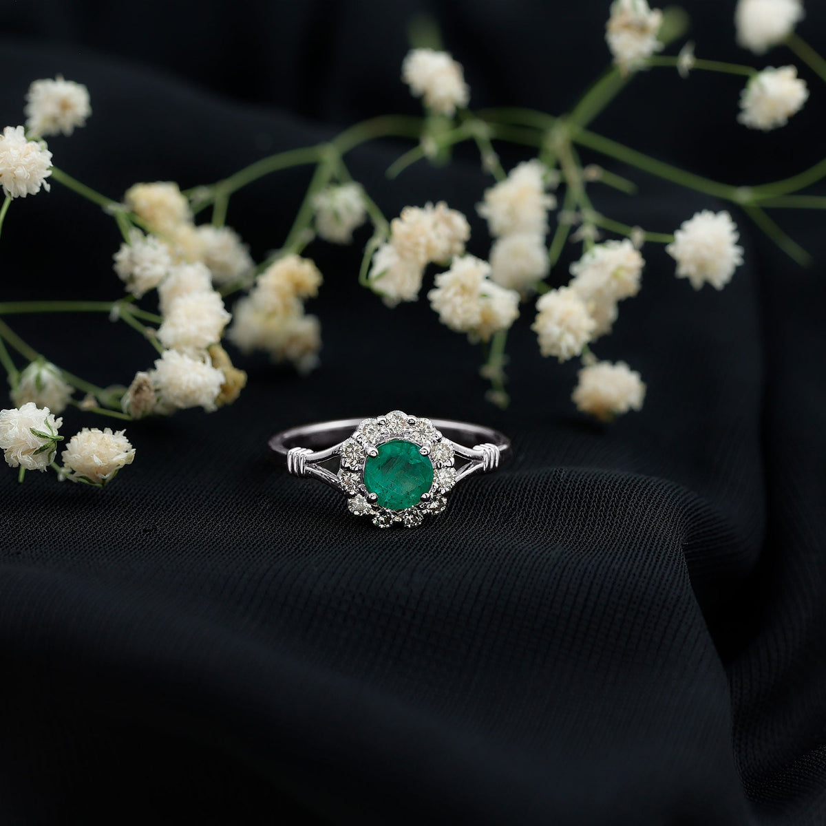 Emerald nature-inspired engagement ring with diamond halo by Rosec Jewels, showcasing intricate design and sparkling gemstones.