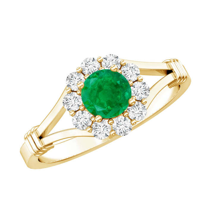 Emerald nature-inspired engagement ring with diamond halo by Rosec Jewels, featuring a central emerald and intricate design.