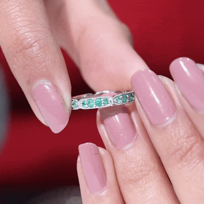Natural emerald eternity wedding band with milgrain detail, crafted by Rosec Jewels, showcasing a continuous row of emeralds and intricate metalwork.