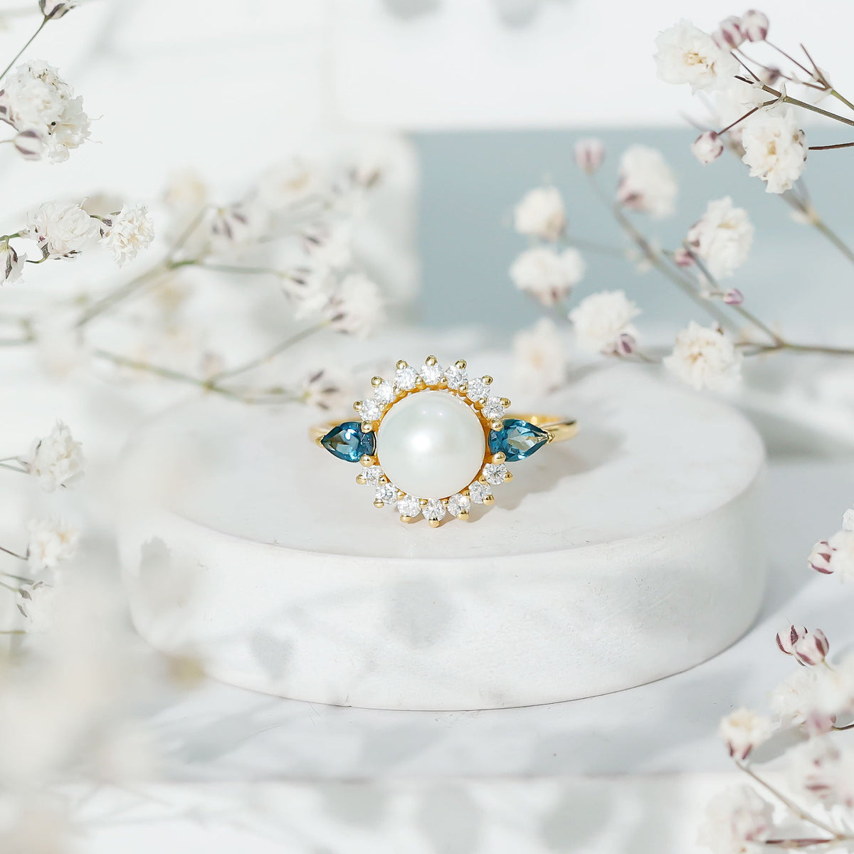 Rosec Jewels 8mm freshwater cultured pearl and blue topaz engagement ring with intricate metal band design.