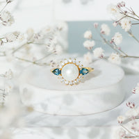 Rosec Jewels 8mm freshwater cultured pearl and blue topaz engagement ring with intricate metal band design.