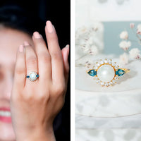 Elegant 8mm freshwater cultured pearl and blue topaz engagement ring by Rosec Jewels, showcasing a polished silver band with detailed design.