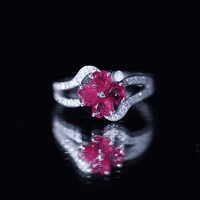 Real ruby flower engagement ring with diamond split shank from Rosec Jewels featuring a central ruby flower and sparkling diamonds.