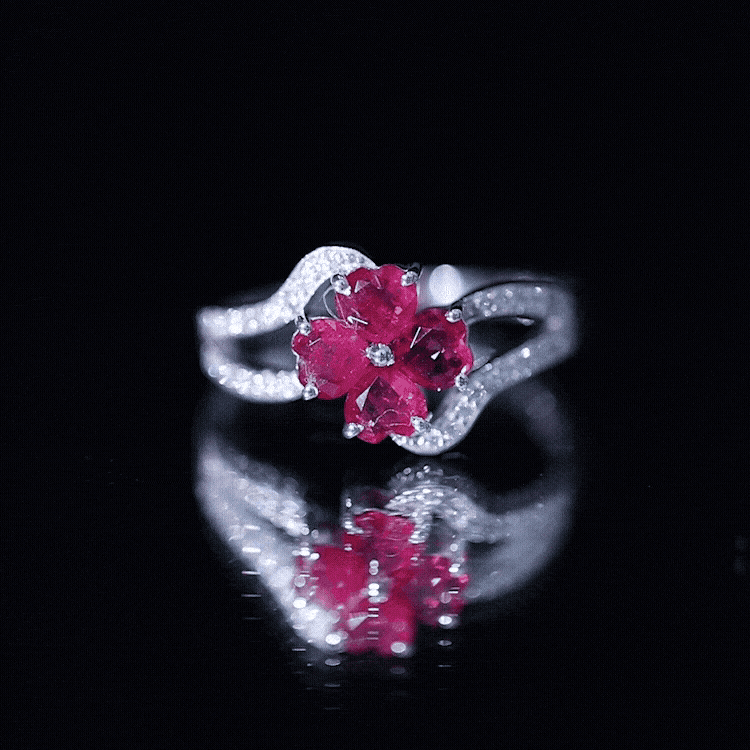 Yellow gold engagement ring featuring a real ruby flower center with diamond accents on a split shank band.