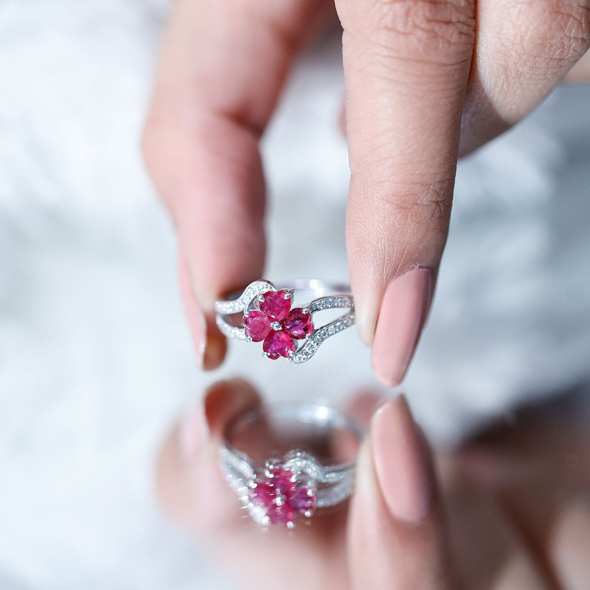 Real ruby flower engagement ring with diamond split shank by Rosec Jewels, featuring a central ruby flower and sparkling diamond accents.