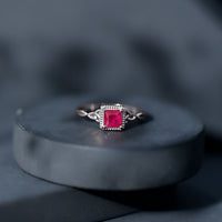 Natural 0.8 carat princess cut ruby promise ring with Celtic knot design, crafted by Rosec Jewels.