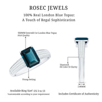 6x8mm emerald cut London Blue Topaz side stone engagement ring with sparkling diamonds, crafted by Rosec Jewels.