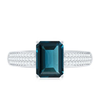 Rosec Jewels 6x8mm London Blue Topaz side stone engagement ring with diamond accents, showcasing elegant gemstone and ring setting.